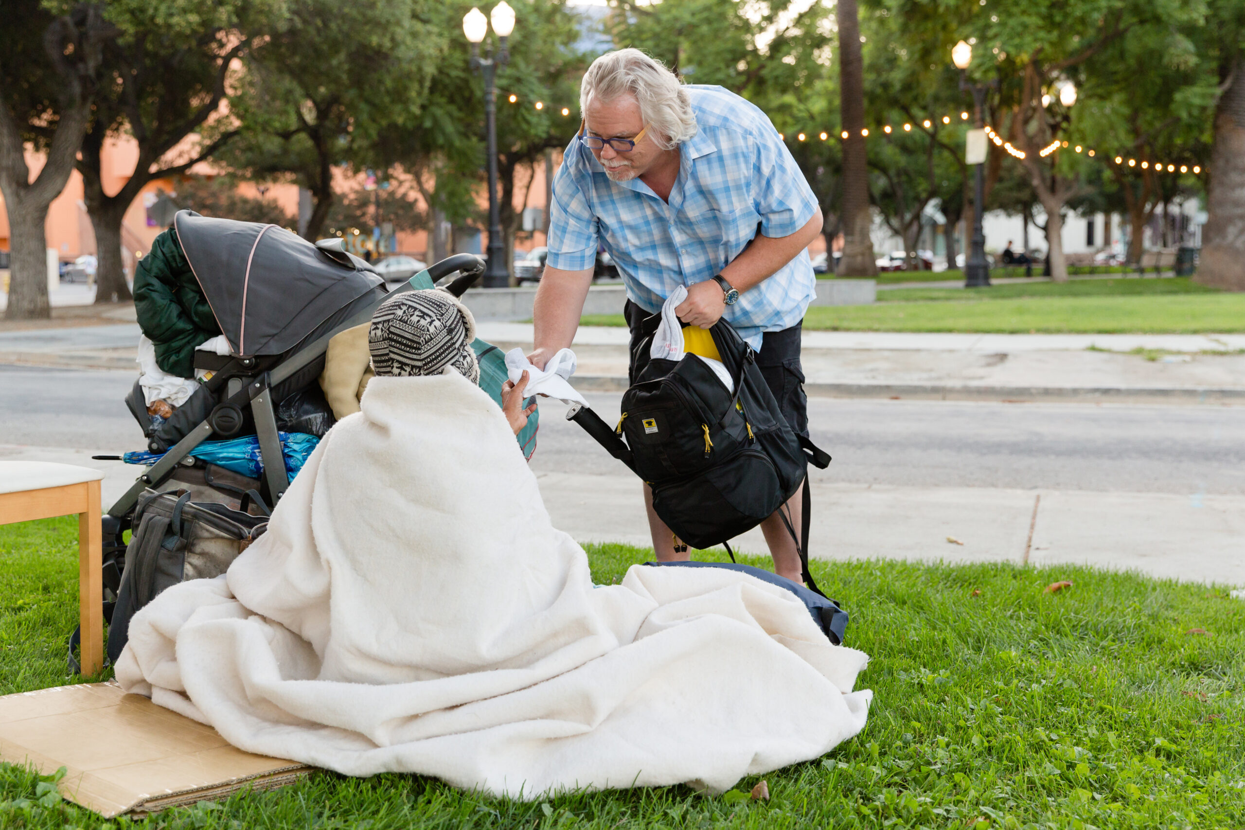 HanesBrands employee handing a homeless person Hanes socks