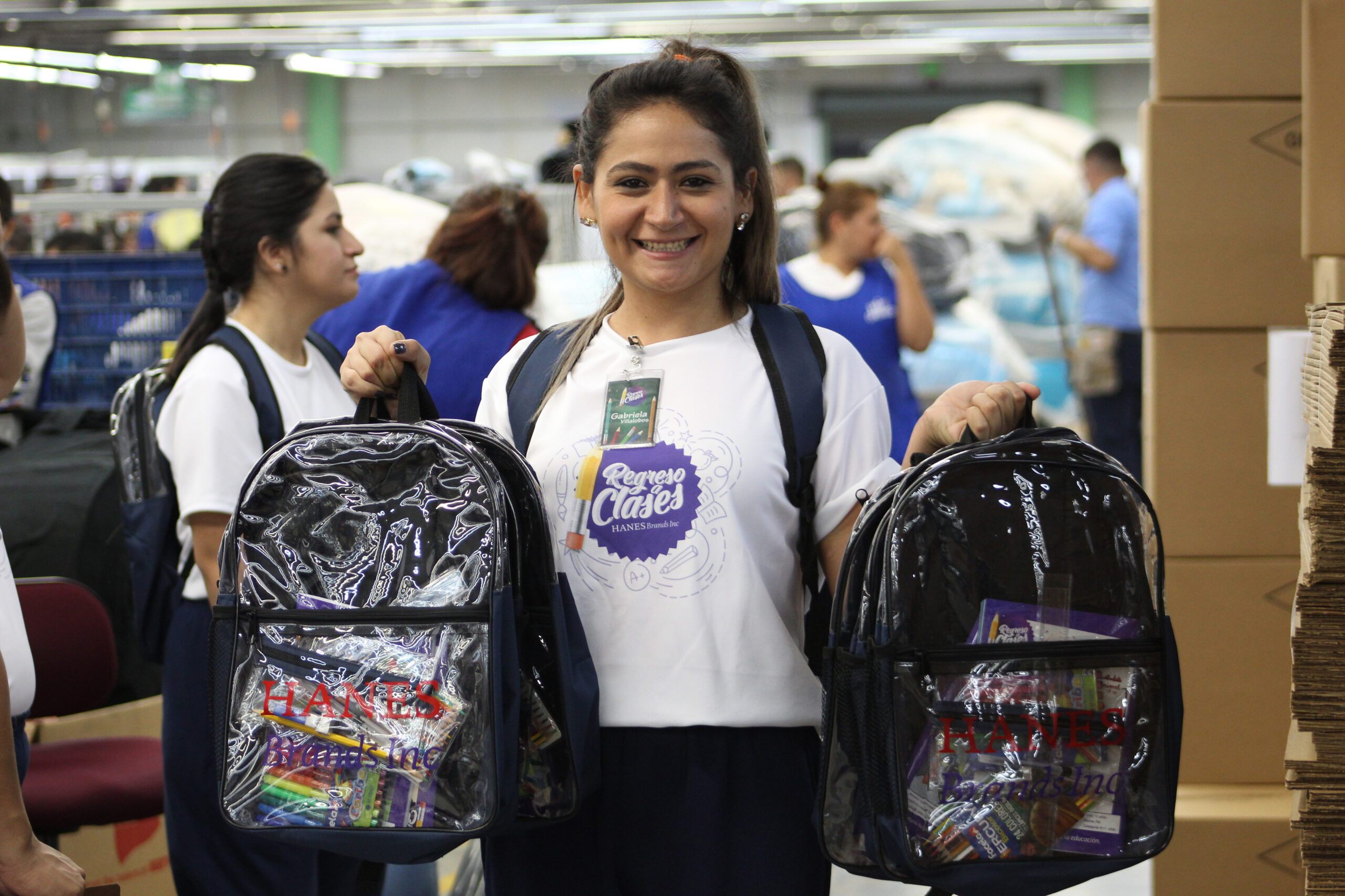 HanesBrands employee passing out school supplies
